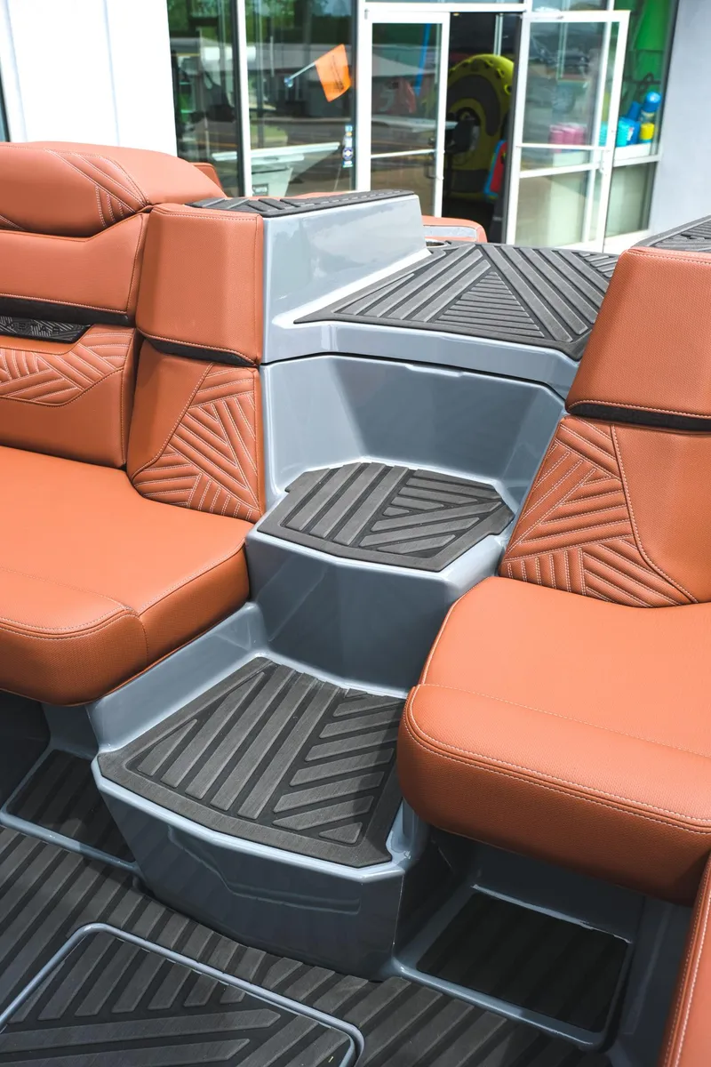 Slide: The Image of 2025 MasterCraft XStar 25 interior with brown leather seats and modern design. - 40