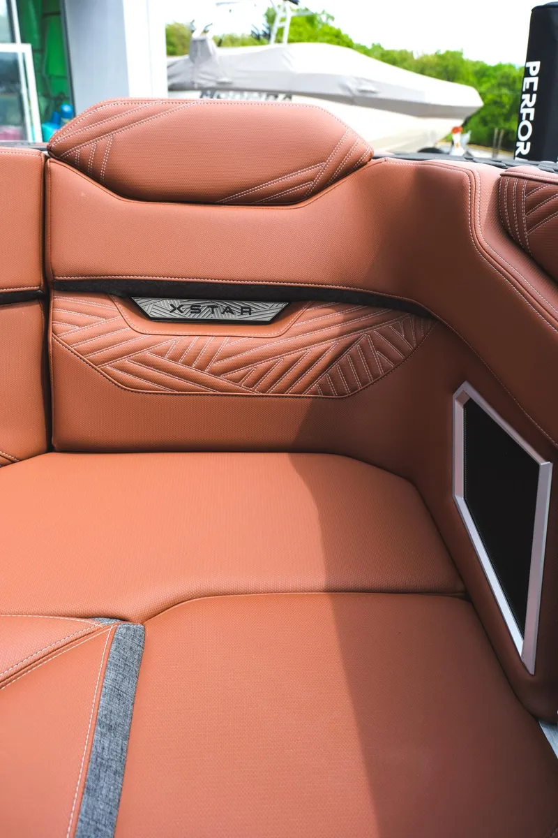Slide: The Image of 2025 MasterCraft XStar 25 boat interior with luxurious brown leather seating. - 41