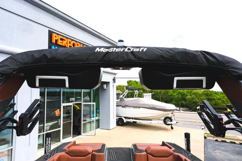 Slide: The Image of 2025 MasterCraft XStar 25 boat with speakers, parked outside a dealership. - 45