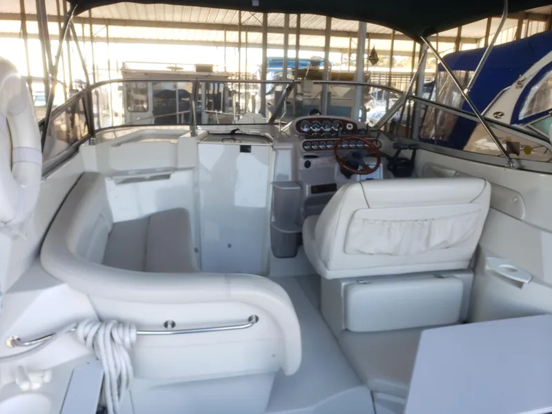 Slide: The Image of 2000 Regal 2860 Commodore boat interior with white seating and control panel. - 11