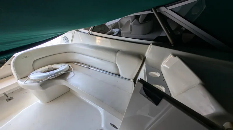 Slide: The Image of 2000 Regal 2860 Commodore boat interior with white seating and cup holders. - 12