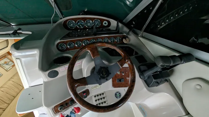Slide: The Image of Control panel of a 2000 Regal 2860 Commodore boat with wooden steering wheel. - 13