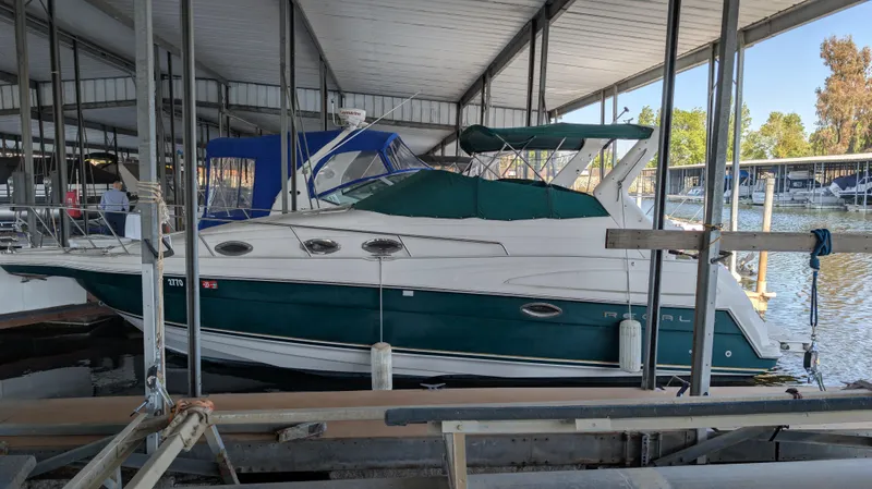 Slide: The Image of 2000 Regal 2860 Commodore boat docked in a covered marina. - 2