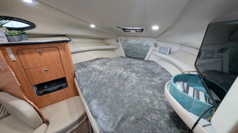 Slide: The Image of Interior cabin of 2000 Regal 2860 Commodore yacht, featuring bed, cabinetry, and modern amenities. - 20