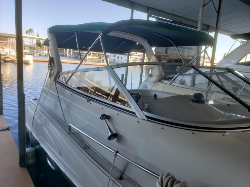 Slide: The Image of 2000 Regal 2860 Commodore boat docked in marina with green canopy. - 3