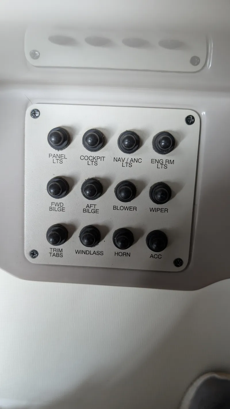 Slide: The Image of Control panel of a 2000 Regal 2860 Commodore boat with labeled switches. - 34