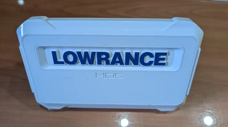 Slide: The Image of Lowrance HDS cover on wooden surface, compatible with 2000 Regal 2860 Commodore. - 36