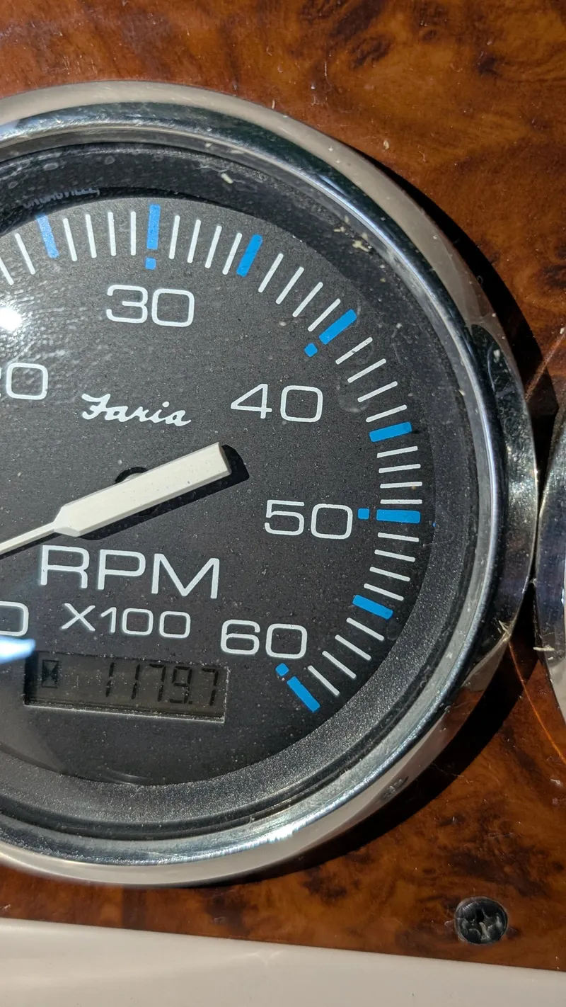 Slide: The Image of Tachometer of 2000 Regal 2860 Commodore showing RPM with wood grain background. - 38