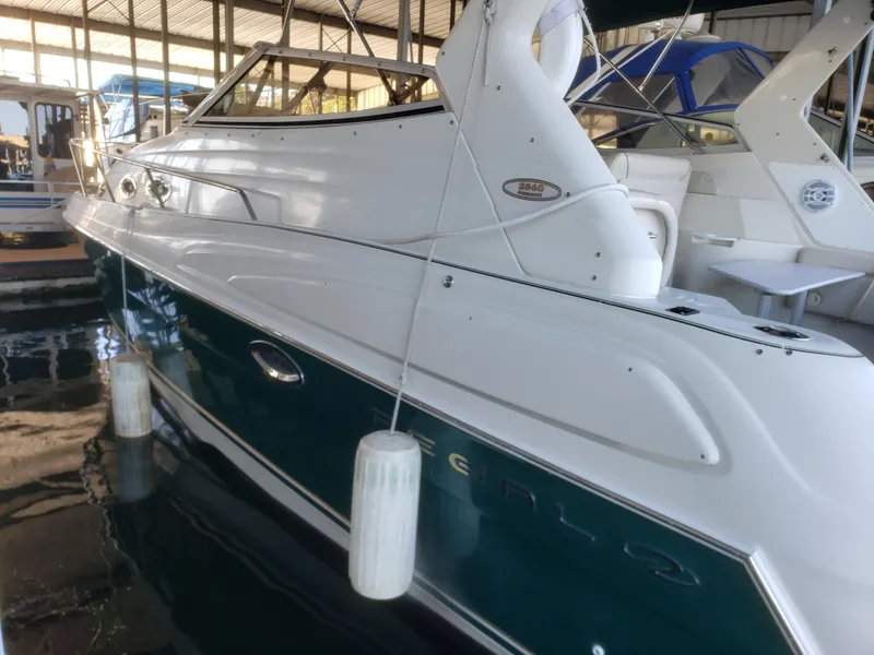 Slide: The Image of 2000 Regal 2860 Commodore boat docked in a marina, side view. - 4