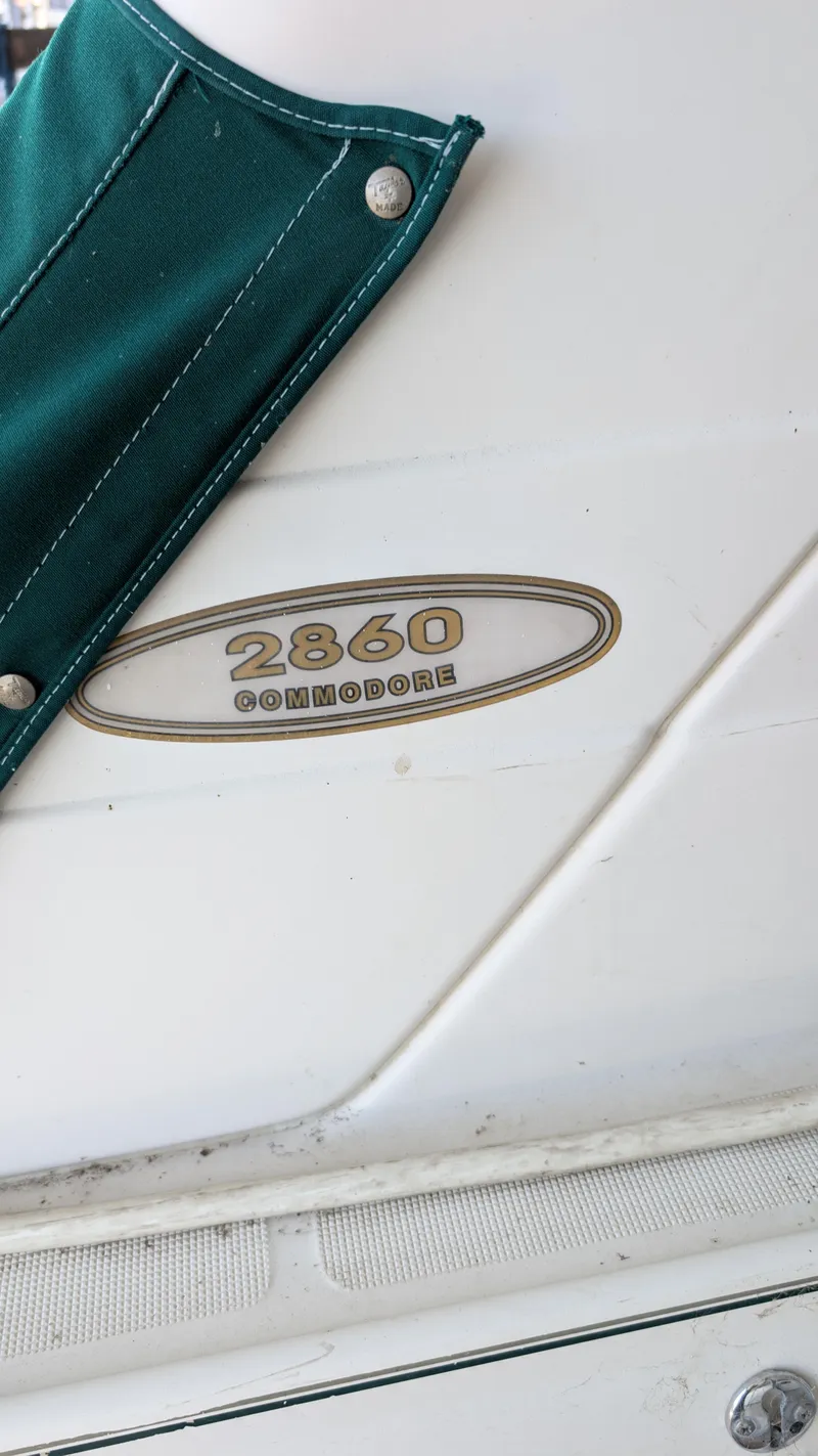 Slide: The Image of 2000 Regal 2860 Commodore boat with green cover and logo detail. - 41