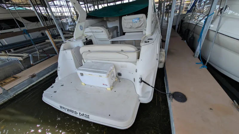 Slide: The Image of 2000 Regal 2860 Commodore boat docked, rear view with seating and storage. - 5