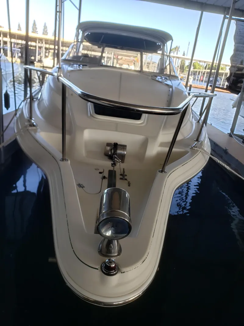 Slide: The Image of 2000 Regal 2860 Commodore boat docked in marina, front view. - 9