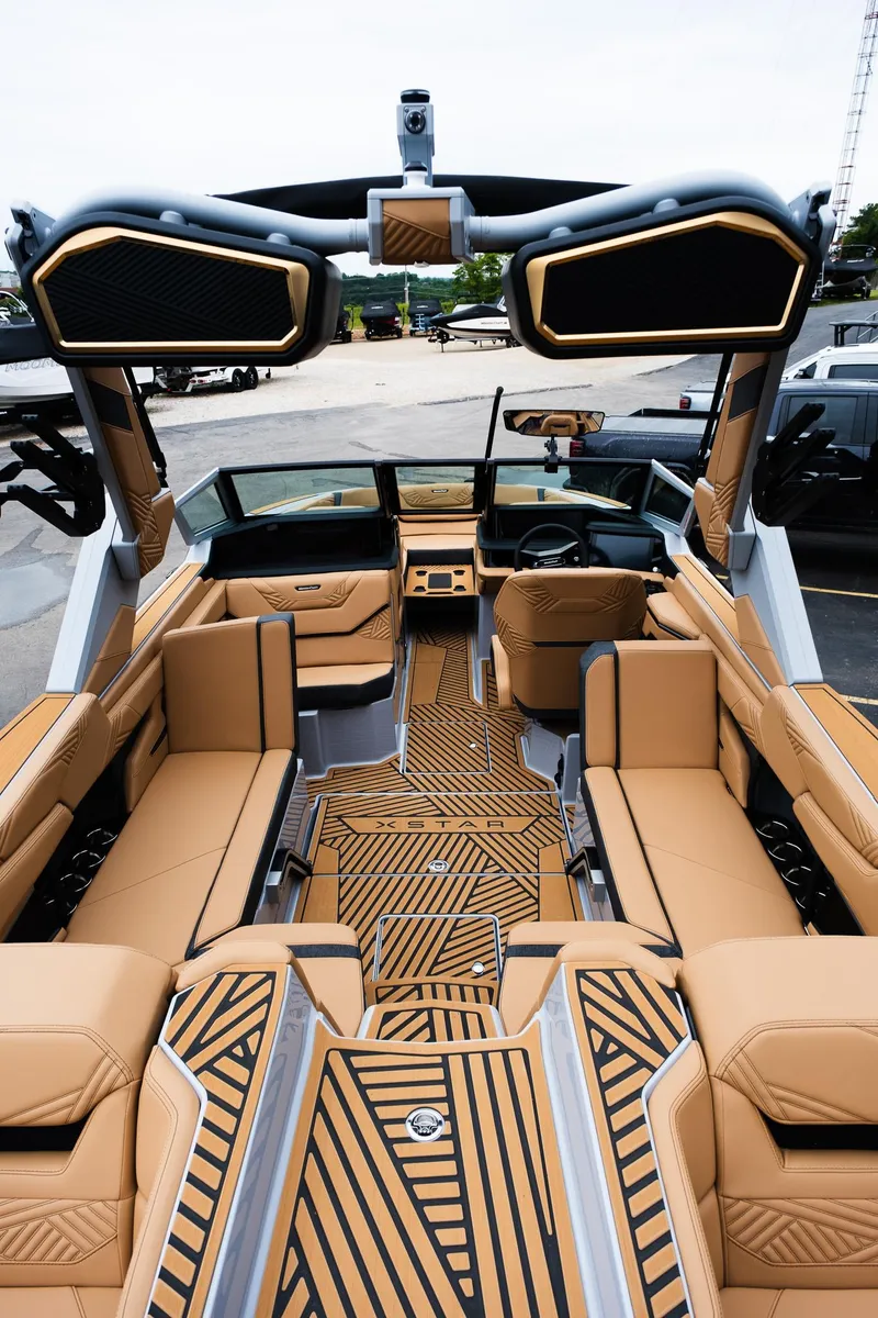 Slide: The Image of 2025 MasterCraft XStar 23 interior with luxurious tan seating and modern design elements. - 11