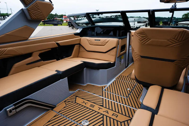 Slide: The Image of 2025 MasterCraft XStar 23 interior with luxurious tan seating and modern design. - 15