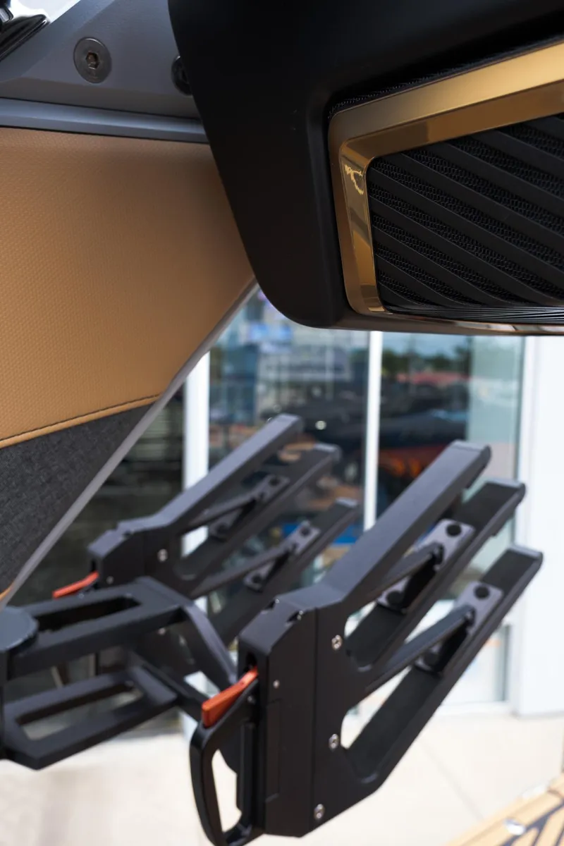 Slide: The Image of 2025 MasterCraft XStar 23 boat with sleek black and gold detailing. - 18