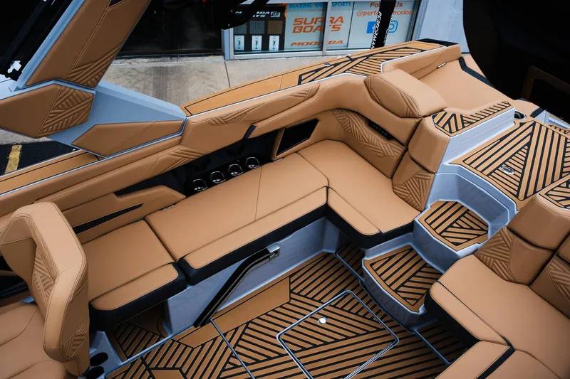 Slide: The Image of 2025 MasterCraft XStar 23 interior with luxurious tan seating and modern design. - 21