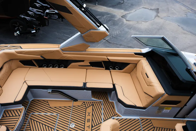 Slide: The Image of 2025 MasterCraft XStar 23 boat interior with tan seating and modern design. - 22