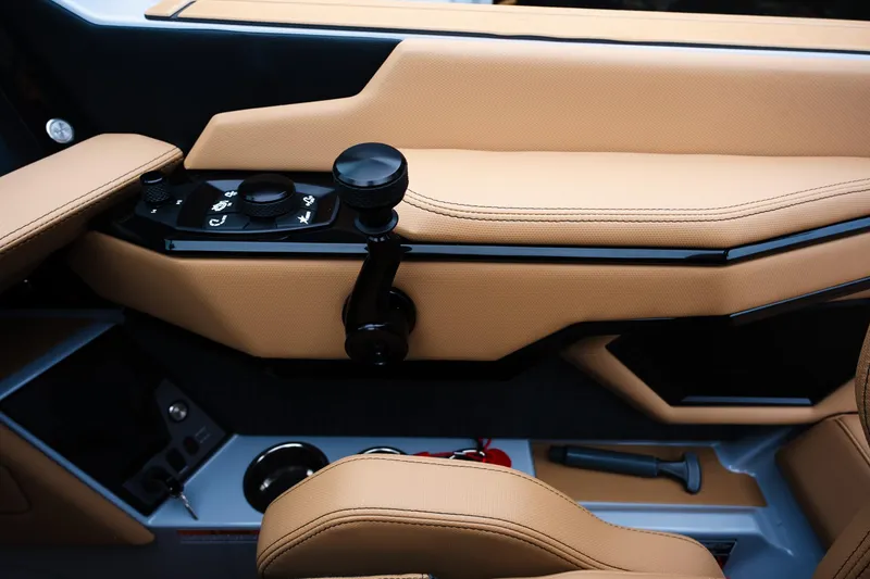 Slide: The Image of Interior of 2025 MasterCraft XStar 23 boat with tan leather and control panel. - 25