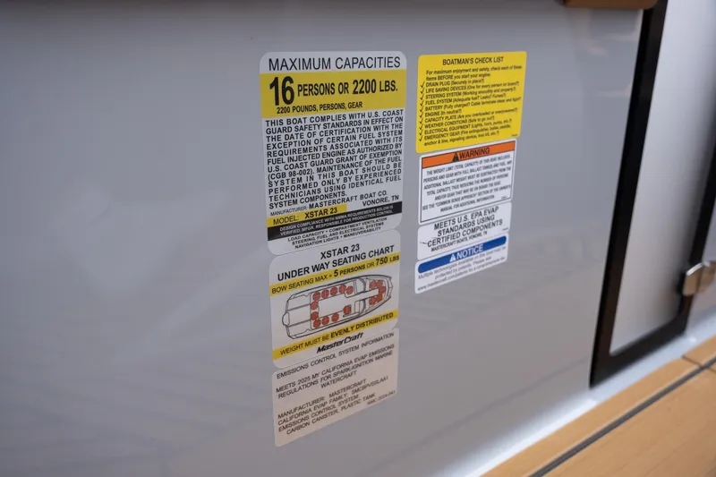 Slide: The Image of 2025 MasterCraft XStar 23 capacity label, seating chart, and safety instructions. - 27