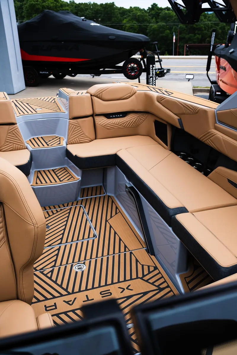 Slide: The Image of 2025 MasterCraft XStar 23 interior with tan seating and stylish flooring design. - 32