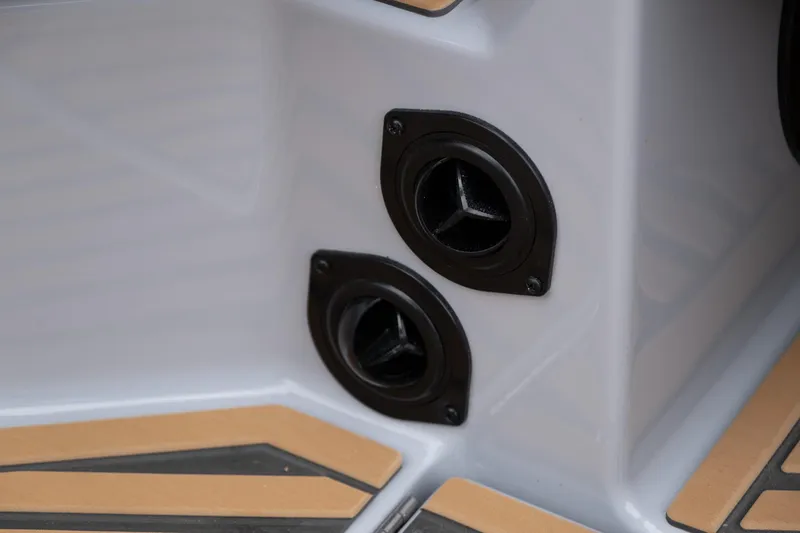 Slide: The Image of 2025 MasterCraft XStar 23 boat interior detail with dual black vents and tan flooring. - 33