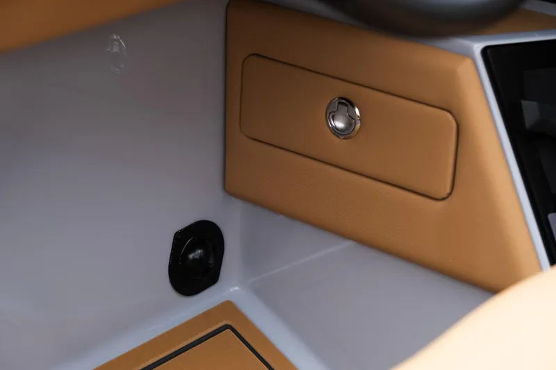 Slide: The Image of 2025 MasterCraft XStar 23 interior detail with tan accents and storage compartment. - 34