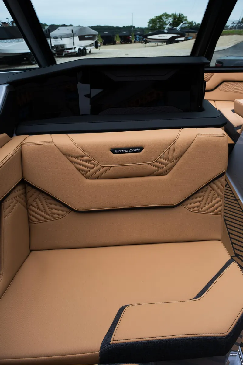 Slide: The Image of 2025 MasterCraft XStar 23 interior with tan leather seating and modern design. - 35