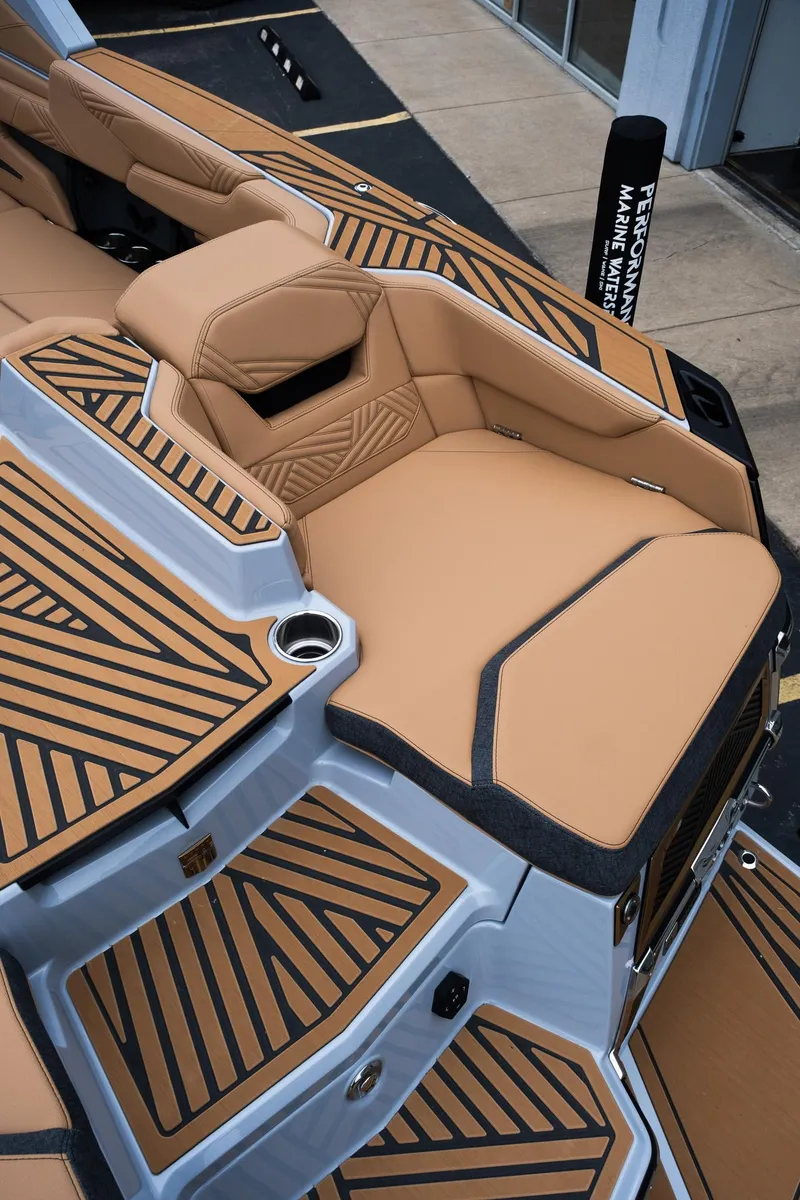 Slide: The Image of 2025 MasterCraft XStar 23 boat interior with tan and black seating and deck design. - 38