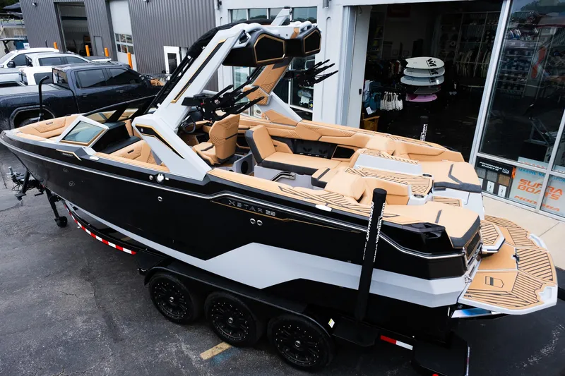 Slide: The Image of 2025 MasterCraft XStar 23 boat with sleek design and luxurious interior on display. - 4
