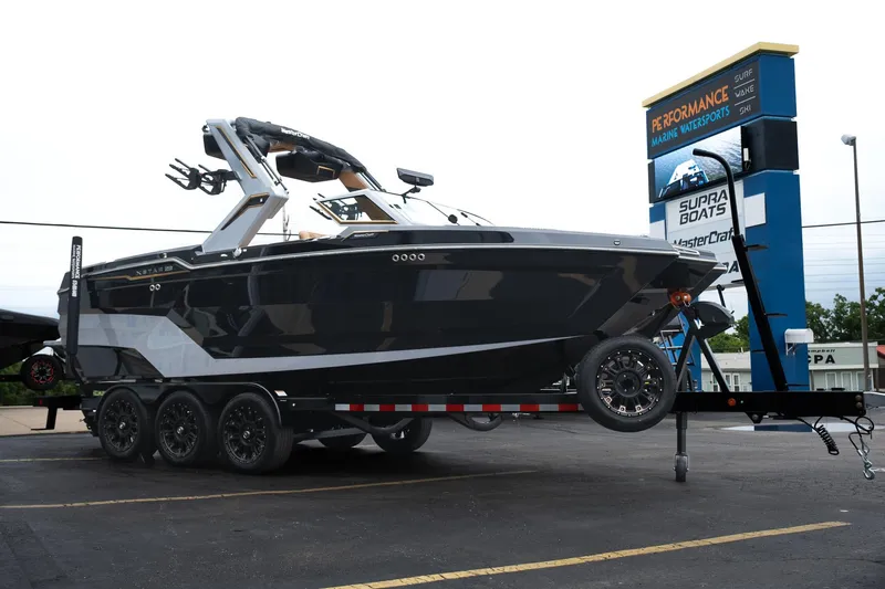 Slide: The Image of 2025 MasterCraft XStar 23 boat on trailer at dealership, showcasing sleek design and modern features. - 42