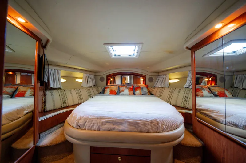 Slide: The Image of Luxurious bedroom interior of 1998 Sea Ray 400 Sedan Bridge yacht with cozy bedding. - 13