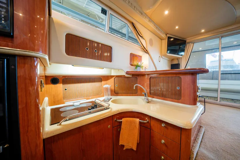 Slide: The Image of Luxurious 1998 Sea Ray 400 Sedan Bridge yacht interior with modern kitchen amenities. - 23
