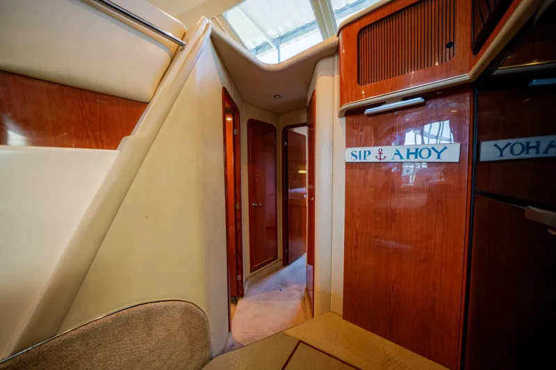 Slide: The Image of Interior of 1998 Sea Ray 400 Sedan Bridge yacht with wooden cabinetry and carpeted flooring. - 24