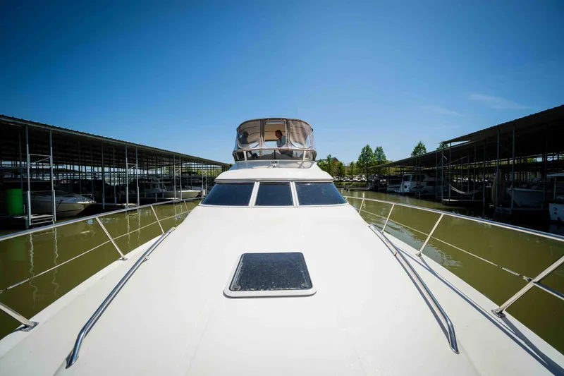 Slide: The Image of 1998 Sea Ray 400 Sedan Bridge yacht docked under clear blue sky. - 28