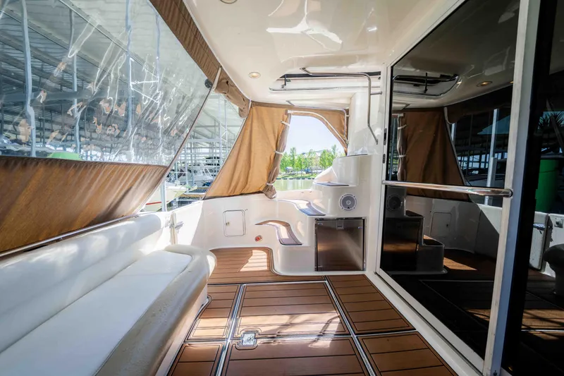 Slide: The Image of 1998 Sea Ray 400 Sedan Bridge yacht interior with white seating and wooden flooring. - 30