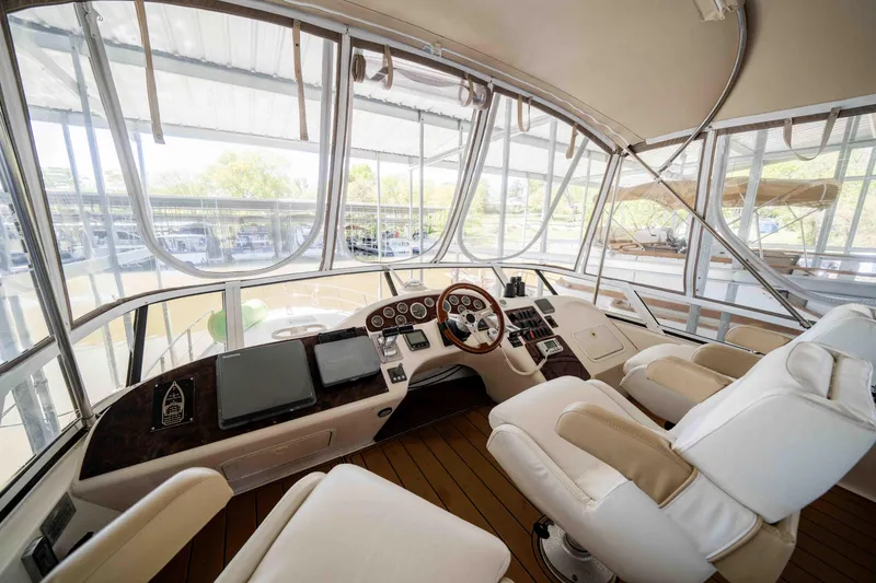 Slide: The Image of 1998 Sea Ray 400 Sedan Bridge helm with modern controls and panoramic windows. - 31