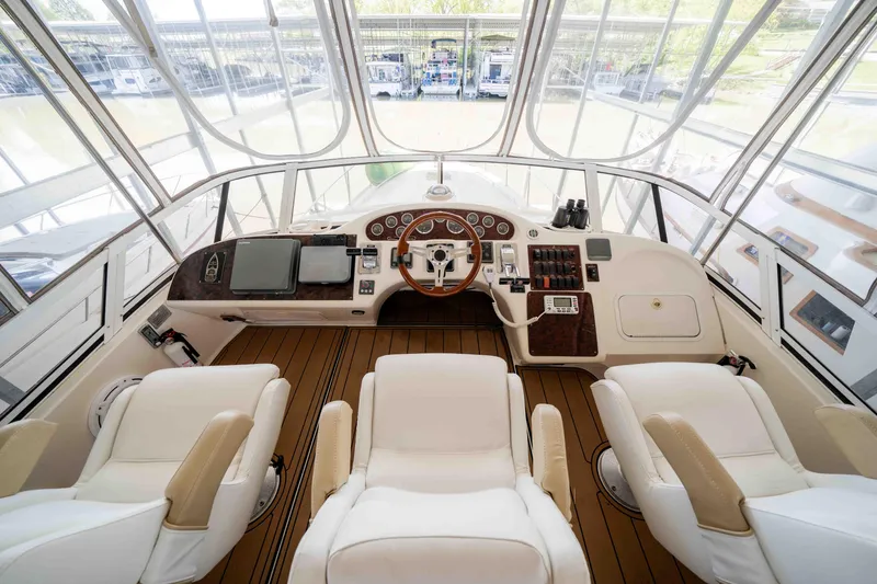 Slide: The Image of 1998 Sea Ray 400 Sedan Bridge helm with luxurious seating and modern controls. - 32
