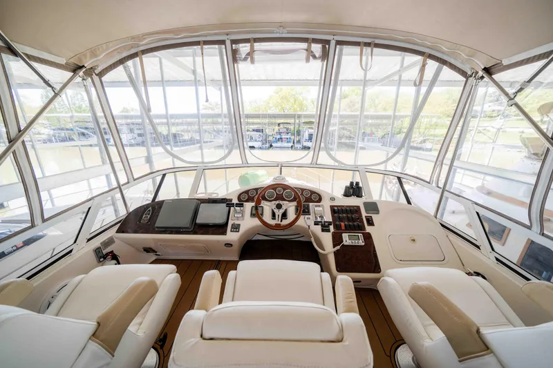 Slide: The Image of 1998 Sea Ray 400 Sedan Bridge helm with panoramic windows and luxurious seating. - 33