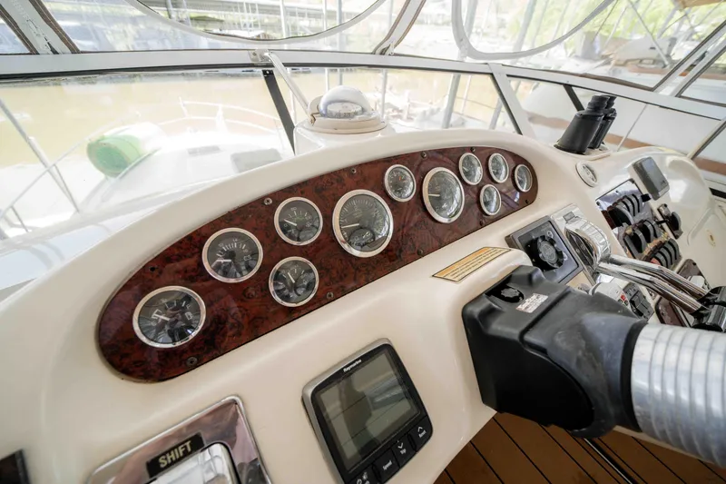 Slide: The Image of 1998 Sea Ray 400 Sedan Bridge helm with gauges and controls. - 38