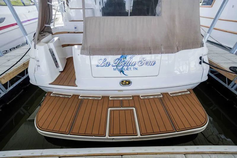 Slide: The Image of 1998 Sea Ray 400 Sedan Bridge yacht with teak swim platform, docked at marina. - 42