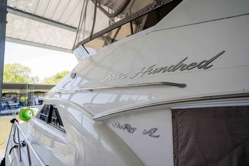Slide: The Image of 1998 Sea Ray 400 Sedan Bridge yacht docked under a covered marina. - 43