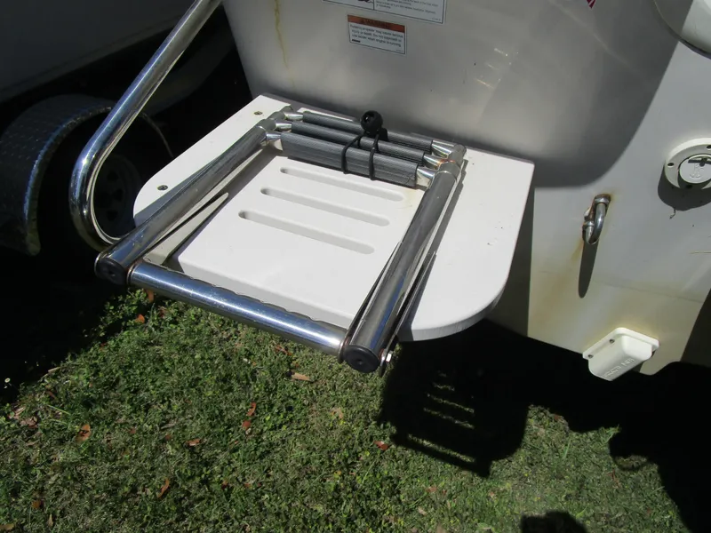 Slide: The Image of 2020 Carolina Skiff 19 LS boat ladder on grass. - 10