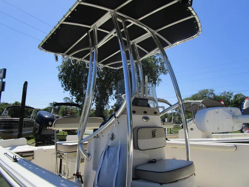 Slide: The Image of 2020 Carolina Skiff 19 LS boat with T-top and seating, displayed outdoors. - 12