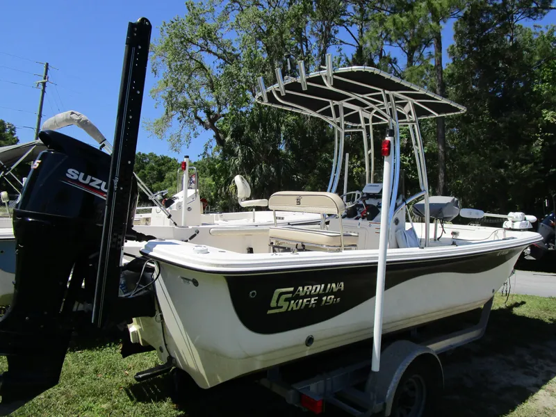 Slide: The Image of 2020 Carolina Skiff 19 LS boat with Suzuki outboard motor on trailer. - 3