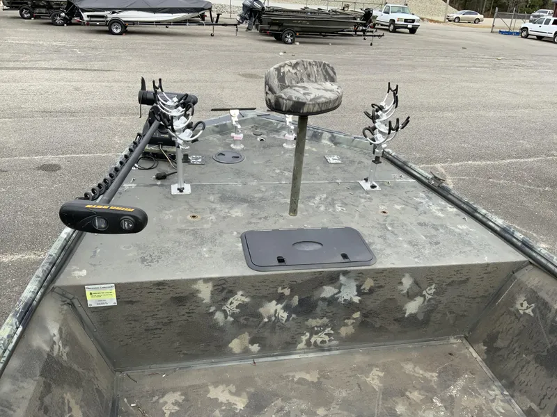 Slide: The Image of 2006 War Eagle 2072CC boat with camo seat, rod holders, and trolling motor in a parking lot. - 5