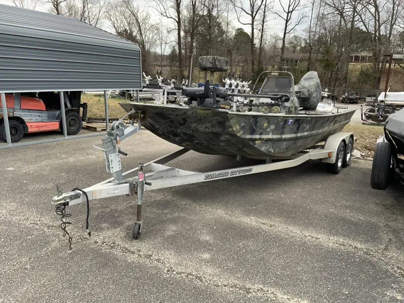 Slide: The Image of 2006 War Eagle 2072CC boat on trailer, parked outdoors near a metal shelter. - 6