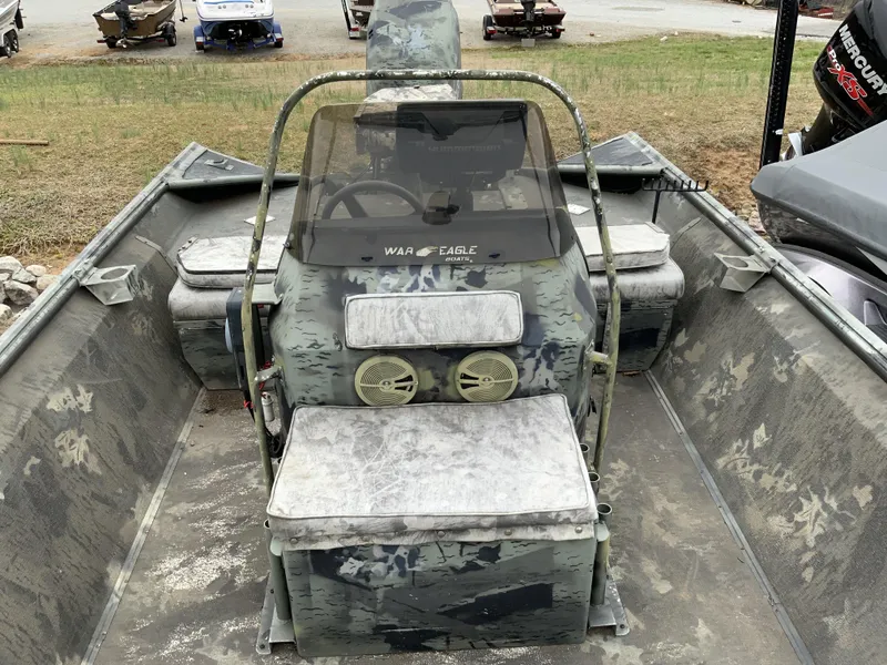 Slide: The Image of 2006 War Eagle 2072CC boat interior with camouflage design and seating. - 8
