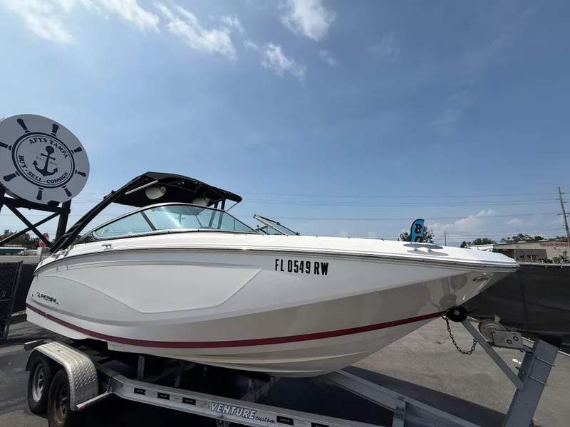 Slide: The Image of 2017 Regal 22 FasDeck boat on trailer under clear blue sky. - 1