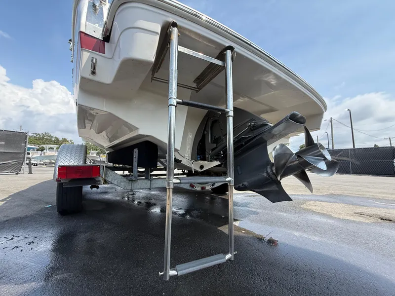 Slide: The Image of 2017 Regal 22 FasDeck boat with ladder and propeller, parked on a trailer. - 10