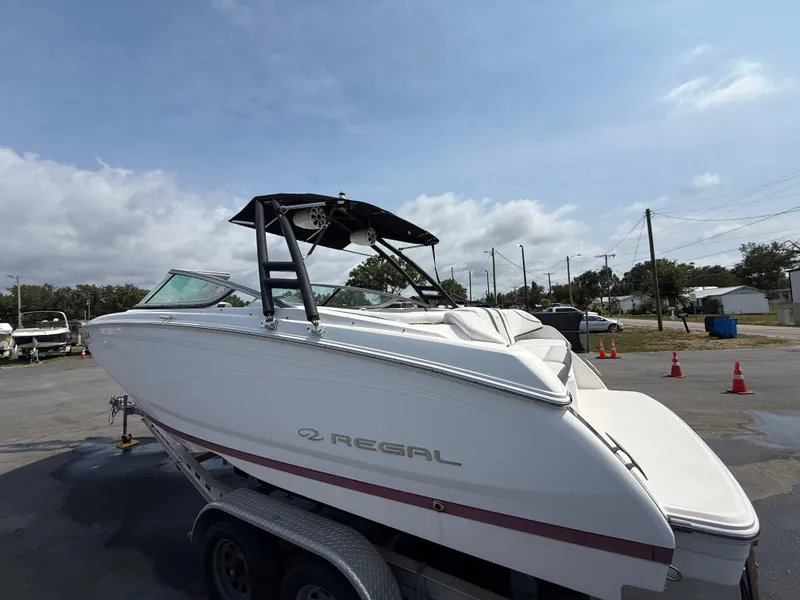 Slide: The Image of 2017 Regal 22 FasDeck boat on trailer under cloudy sky. - 11